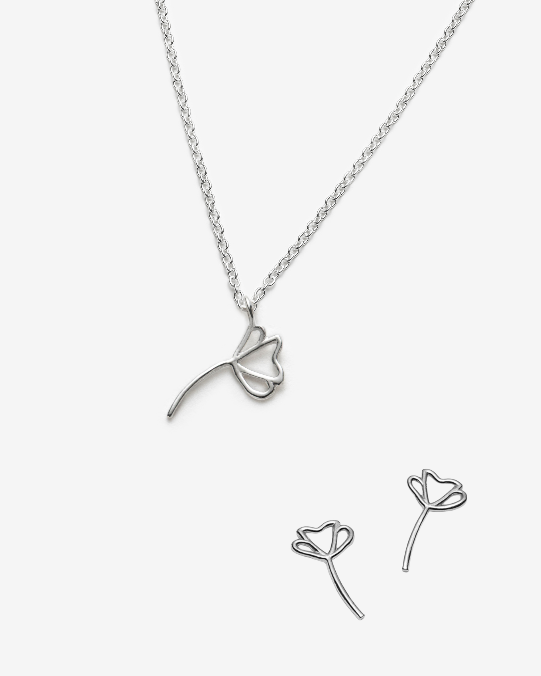 Silver floral necklace and earrings on a white background