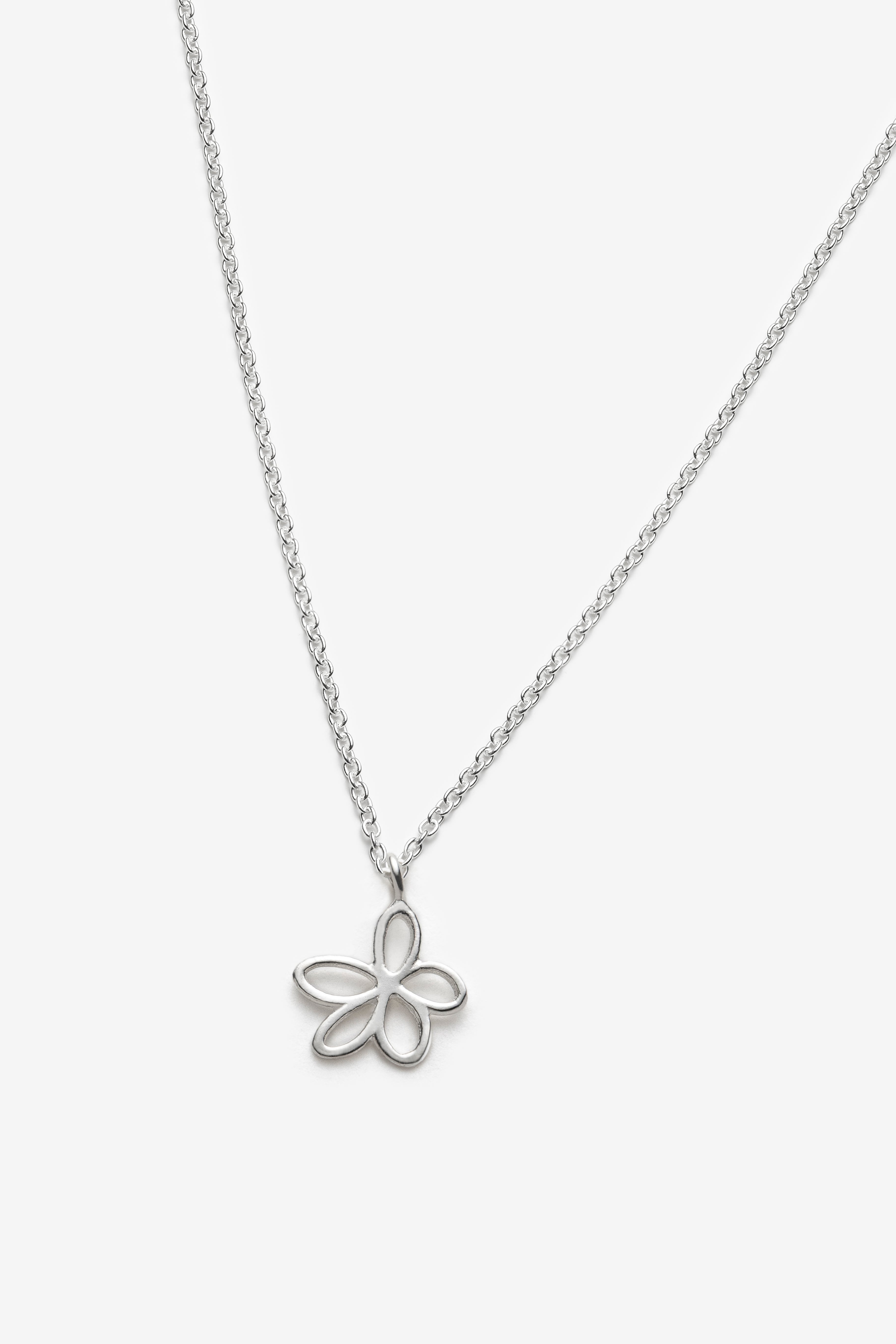 Silver necklace with a flower pendant on a white background