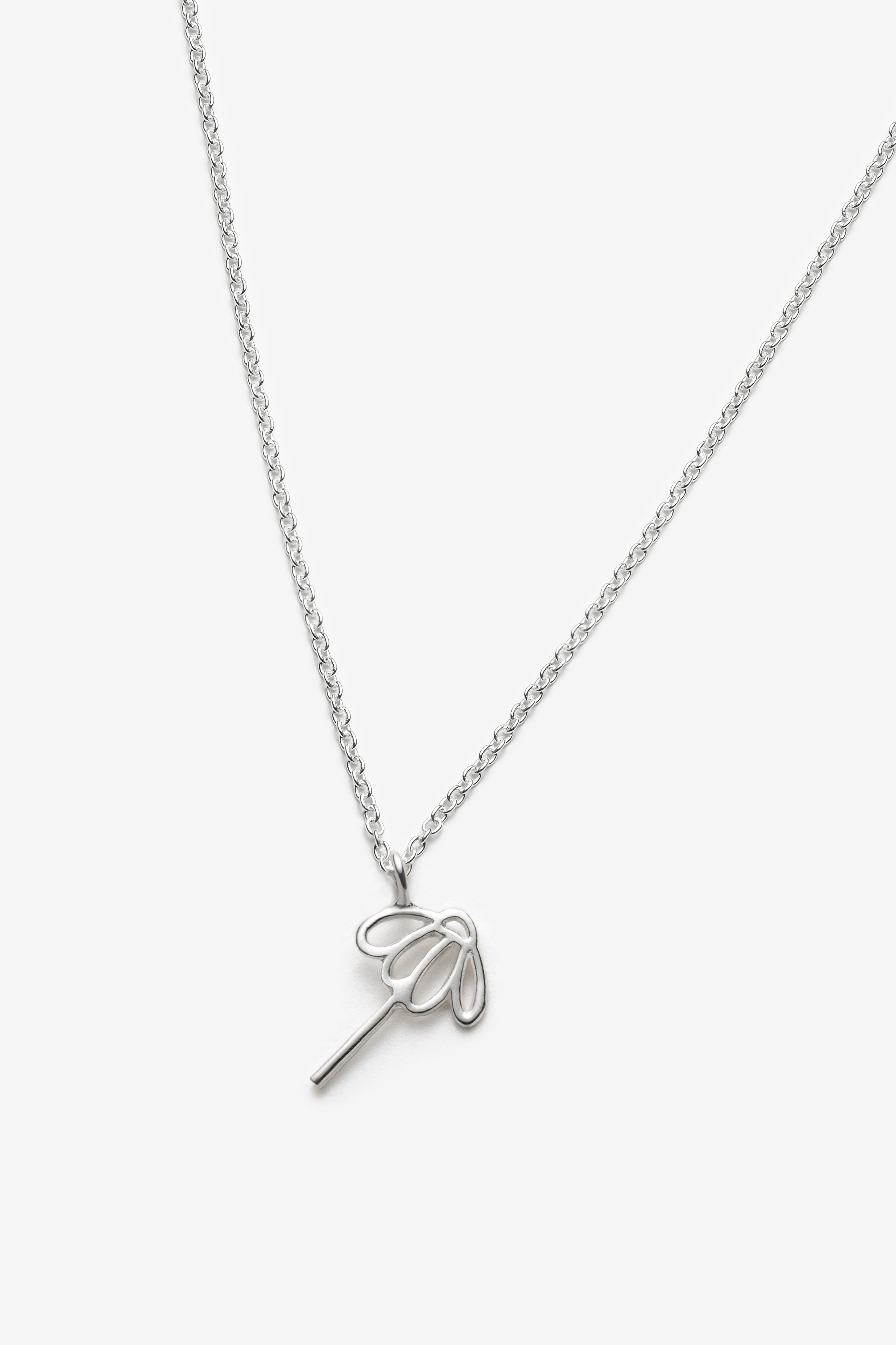 Silver necklace with a sunflower pendant on a white background